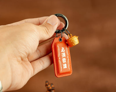 Career Breakthrough Amulet clipped as a keychain, held in hand